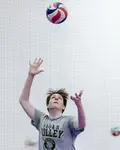 The volleyball toss for the overhand serve needs to consistently be two feet up in the air and one foot in front of front foot which puts the ball in front of your serving arm. 