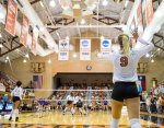 Texas Longhorns volleyball server with stadium panorama