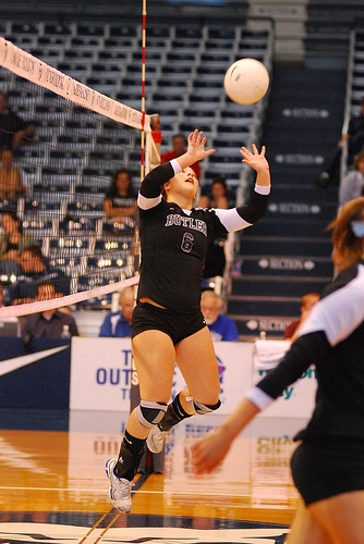 Setting Volleyball Jargon: If a setter sets a ball to a hitter who scores a point with a kill, the setter gets credit for "assisting" in the positive result which is the point.