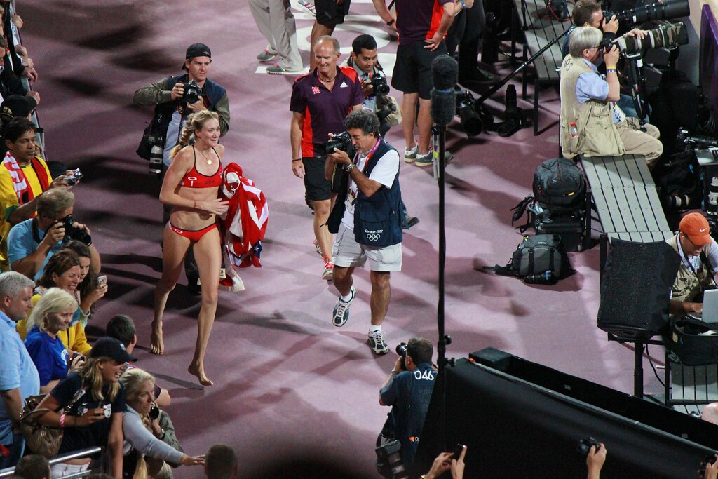 Kerri Walsh victory run with flag after winning the Olympic gold medal at the London Olympics. Louis Crusoe