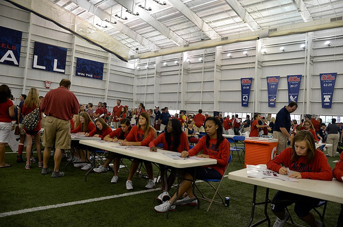Ole Miss players sign the Rebels volleyball poster during their preseason autograph session for fans and supporters.