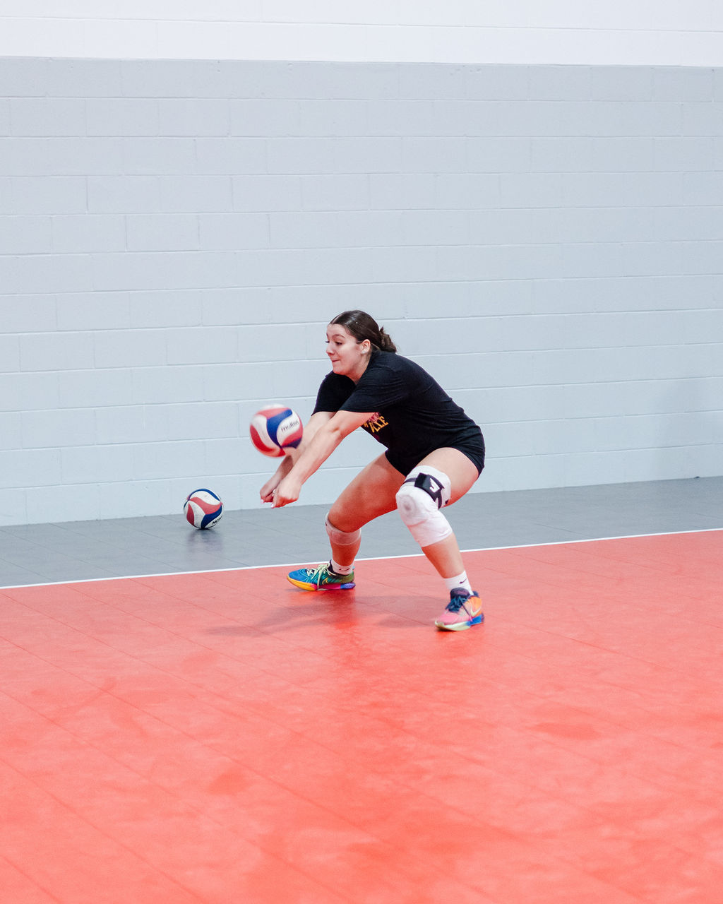 One way we teach passers to control the ball is to drop their hips lower than the level of the oncoming ball which helps you contact the ball to forearm pass it from a lower point.

With your hips lower than the oncoming served ball you can get under it and give it lift from a better angle with your legs. (Shots by Shanty)