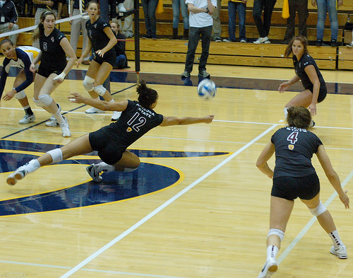 The Cal Berkeley hitter tipped the ball to the middle of the court over the Arizona State double block while the A State off side blocker attempts to dig the ball in defense.(RRaiderstyle)