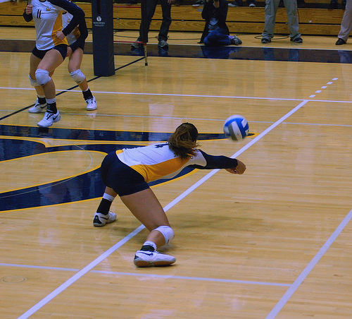 Cal State Bears off side blocker digs the tip attack hit from the opposing team which is aimed to land behind her blockers. (RRaiderstyle)