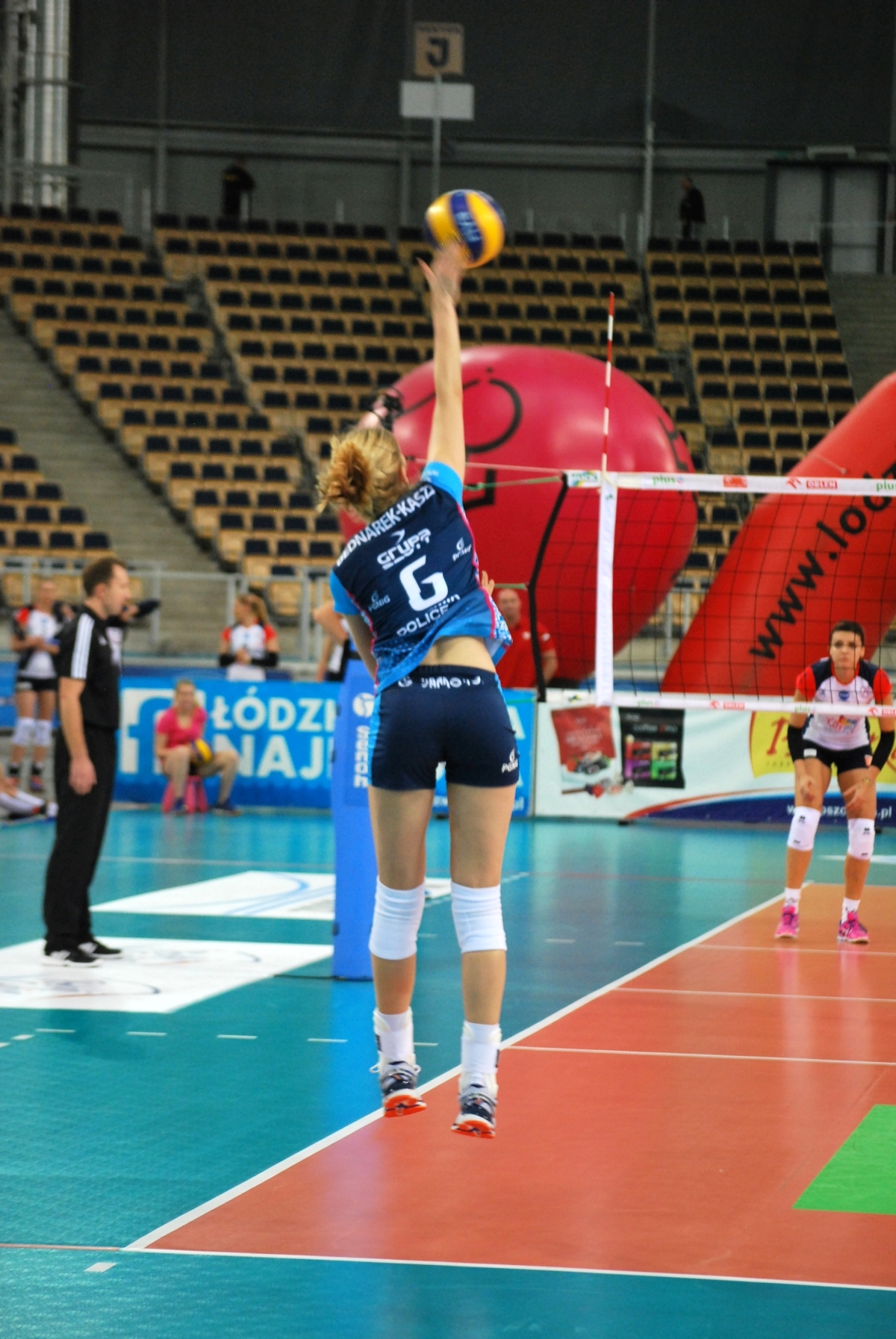 Serving from behind the service line allows players to generate enough power and height to clear the net and target specific areas of the opposing team's court.

Agnieszka jump float serve height (photo by zorro2212)