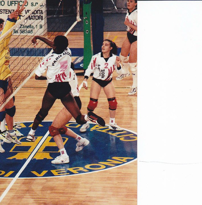 Volleyball Game Rules: Coach April, pro volleyball player in Italy, attacking during a rally.