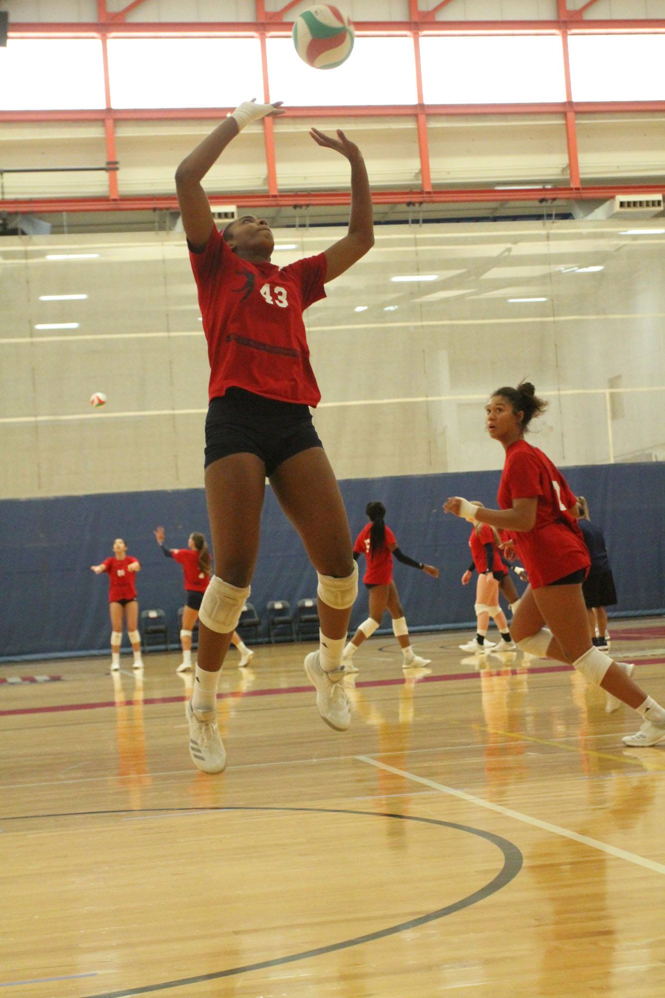 As a setter in volleyball you want to quickly bring both arms up in front of you and as your arms come up, bring them closer together. (USA Volleyball)