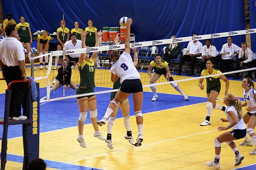Court Volleyball Positions- Outside hitters hit different types of sets to beat the block by hitting the ball hard from the left side of the court known as Zone 4. (JMR Photography)