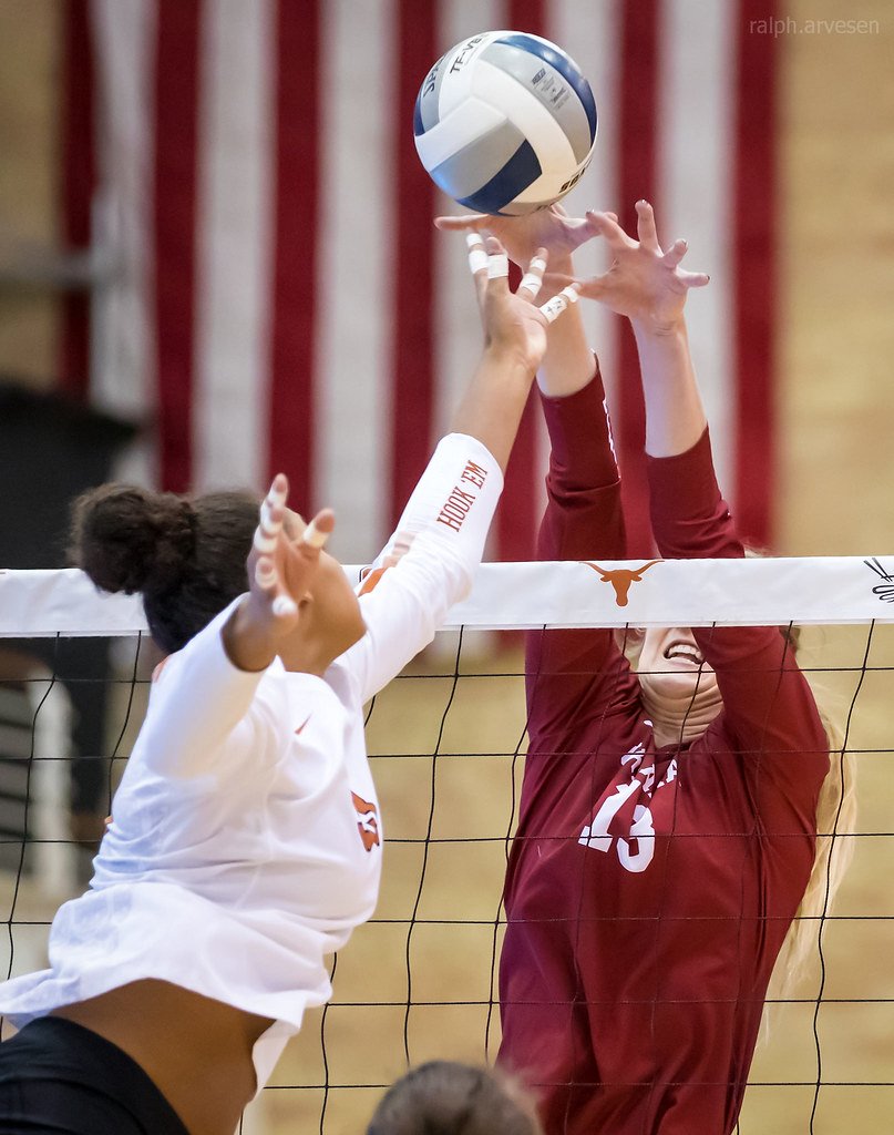 Middle Blocker Training: Oklahoma blocker with proper blocking finish- hands and arms sealing off space between her armpits and the net to reach as far over the net as possible. (Ralph Arvesen)