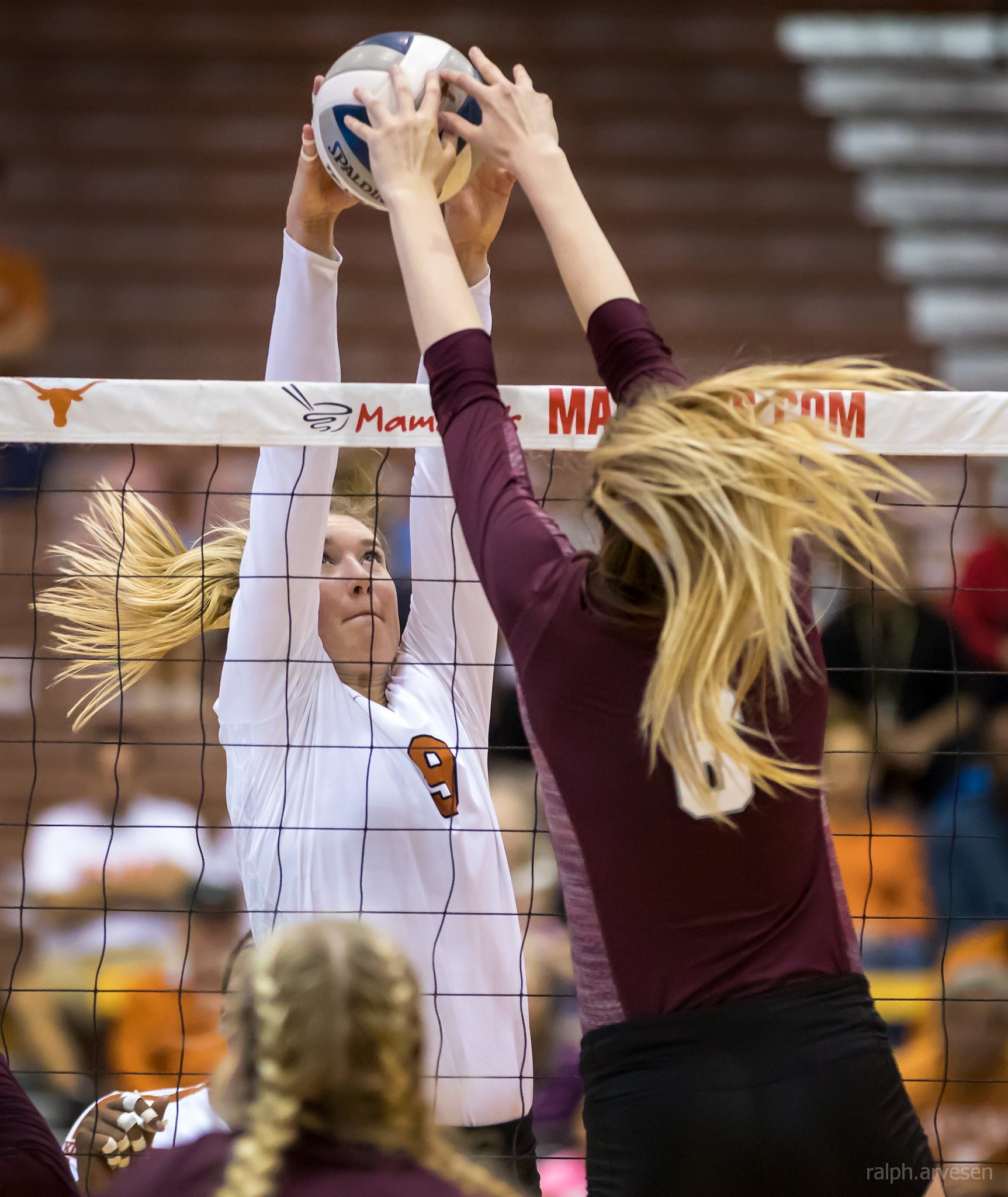 Volleyball joust Texas block and Texas A&M over the net. Photo by Ralph Aversen.