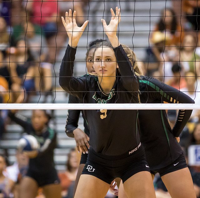 The ready position in volleyball blocking for arms: elbows bent at 90 degrees with hands, widespread fingers and open palms facing the net just at/above shoulder level. (Aversen)