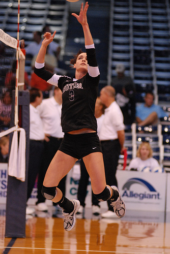 Communicate in volleyball. Left handed front row setter dumps the ball over the net.
