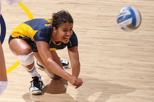 Why does one volleyball player have a different color jersey at the  Olympics?