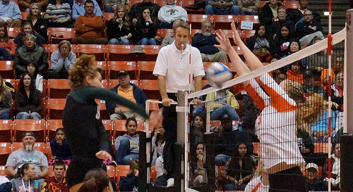Volleyball officials: First referee calls the game from an elevated referee stand while officiating the two teams competing against each other.