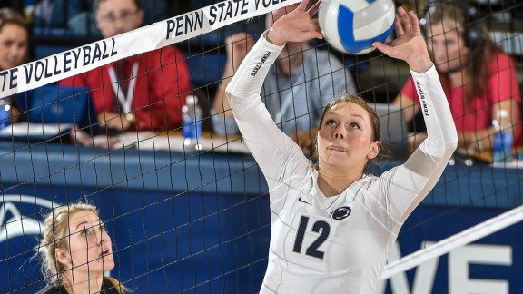 The Middle Blocker Position in Volleyball: Penn State setter Micha Hancock (12) is watched by Iowa Hawkeyes middle blocker in match against Iowa at Rec Hall. (Photo by Mark Selders)