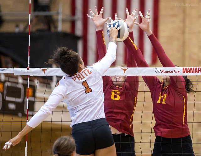 Blocking Volleyball Terms and Definitions: Iowa State Cyclones double block seals the net in order to block Texas hitter Micaya White from attacking hard into their court. (Ralph Arvesen)