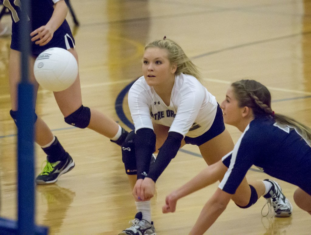 A volleyball defensive player like a libero or defensive specialist needs to be aggressive in the backrow while passing, digging and communicating well. (Keith Allison)