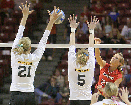 Middle Blocker Volleyball Position: Middle blockers travel laterally along the net to put up a block by themselves or with their outside blockers to stop a hit cross the net. (Bill Shaner)