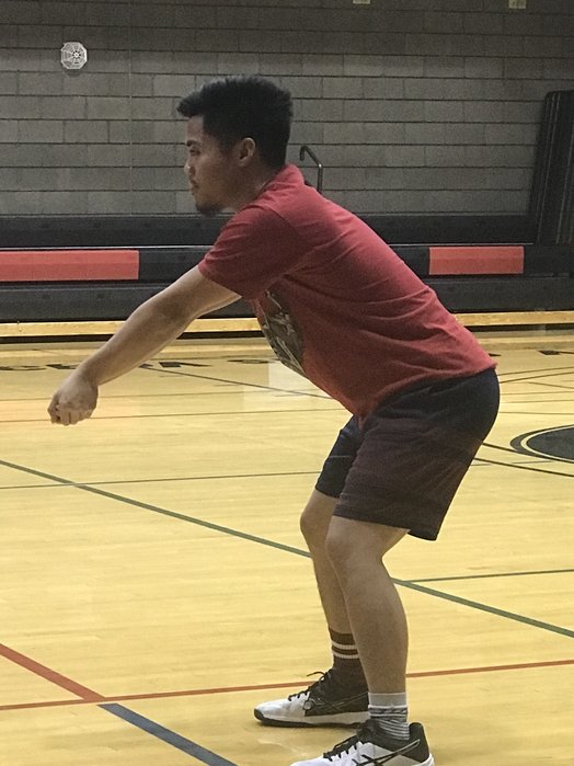 How to bump a volleyball: Keep your elbows straight by pointing your thumbs to the ground when you bump a volleyball. (photo April Chapple)