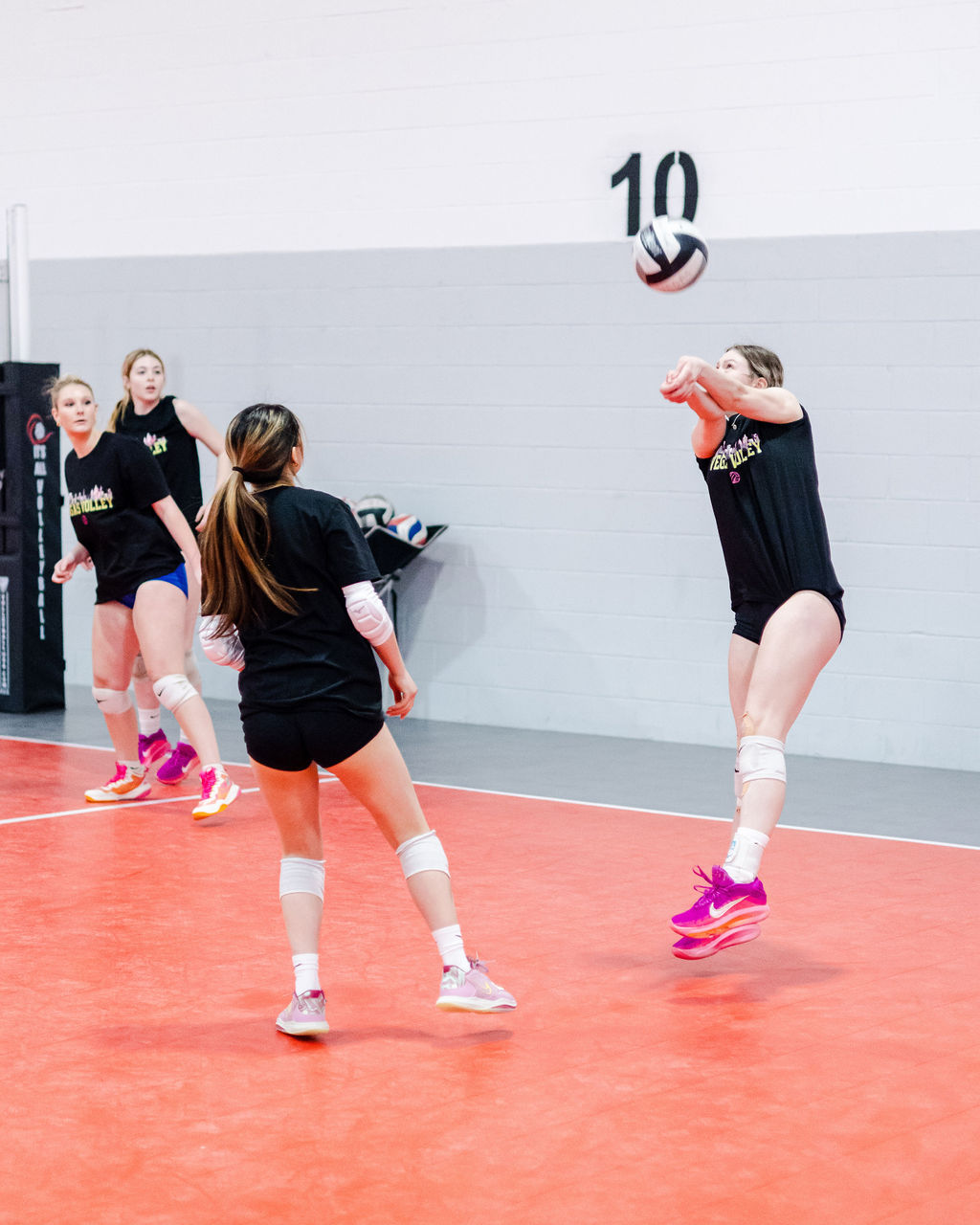 Watch team captain Sofia as she passes a high float serve that's coming at head and shoulder level which is usually a passing challenge but we've worked on opening up to one side while keeping shoulders level while dropping one foot back and keeping the inside shoulder lower while
moving the belly button out of the way so the body is balanced but better able to form an angle with the passing platform to present to the ball without swinging the arms.