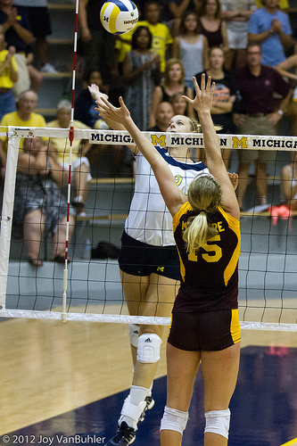 Volleyball Block Technique: The blocker's arms reach outside her body and hands are facing out of bounds so the blocker increases the chances of the hitter using her block. (Joy Van Buhler)