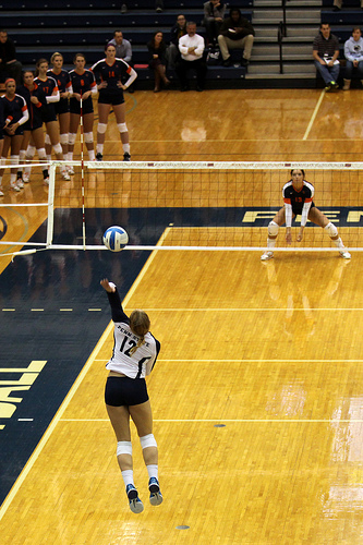 To forearm pass a volleyball you clasps both arms together at the wrists, usually one palm of the hand inside the other while contacting the ball on the forearms (Richard Yuan)