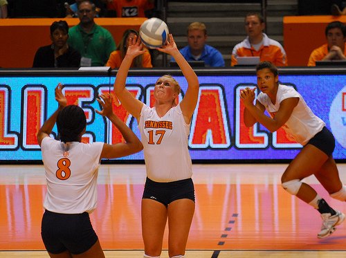 Volleyball Setter Training - When contacting the ball get your feet to the ball quickly so you are directly underneath it before you contact it... your straight arms distance above your head ....while keeping your back straight with no bending at the waist and hips. 
(Tennessee Volleyball Setter  Photo by Tennessee Journalist)