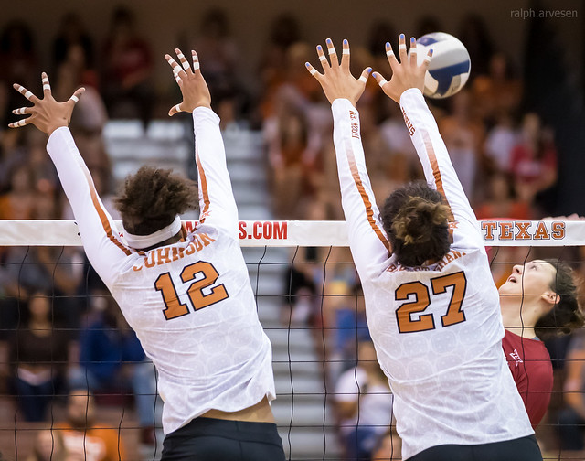 Middle Blocker Volleyball Position Offensive and Defensive Duties: Texas Longhorns middle blocker and outside hitter blocks cross court together against the attack (Ralph Arvesen)