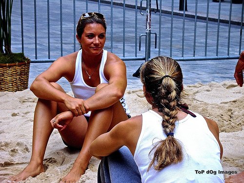 Former teammates Misty May Treanor and Kerri Walsh Jennings talking to each other between volleyball tournament matches. (Top Dog images)