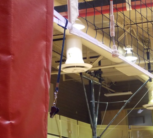 The volleyball antenna base? They are attached to the net and represent a vertical extension of the sideline of that extends up above them to the ceiling and below them to the floor.