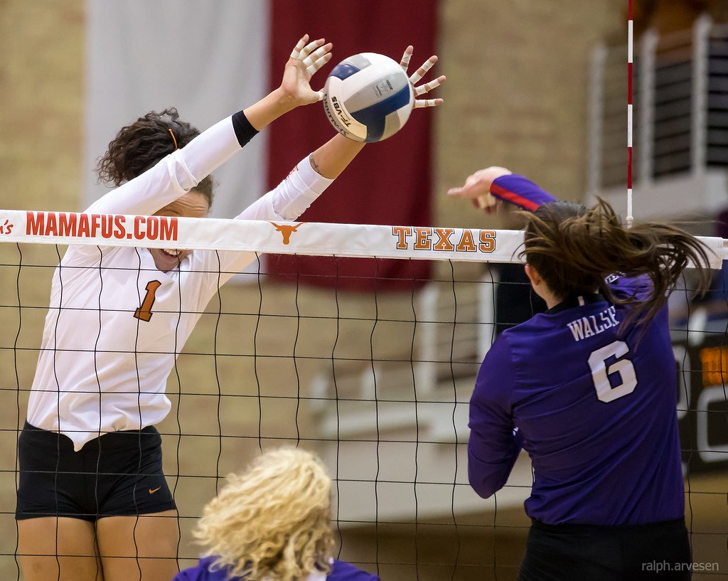 Volleyball Blocking Tips: Watch your hitter with your shoulders parallel to the net as you reach over to  block the ball or stop the ball on the opposing team's side of the net. (Ralph Arvesen photo)