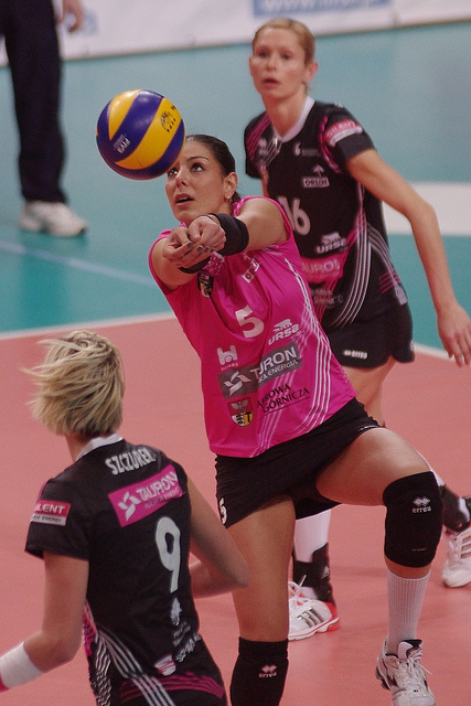 If you take a look at photos of players whether high school varsity, collegiate or professional or beach pros who are in the process of bumping a ball, note how they always work on presenting a nice flat platform by holding their arms as straight as they can while they pass the ball.: pro player passing (Jaroslaw Popczyk)