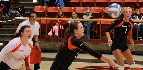 What's a pass in volleyball? One of the three most common ways that one player tranfers a ball to another by holding hands together and using their forearms. (photo Inky Hack)